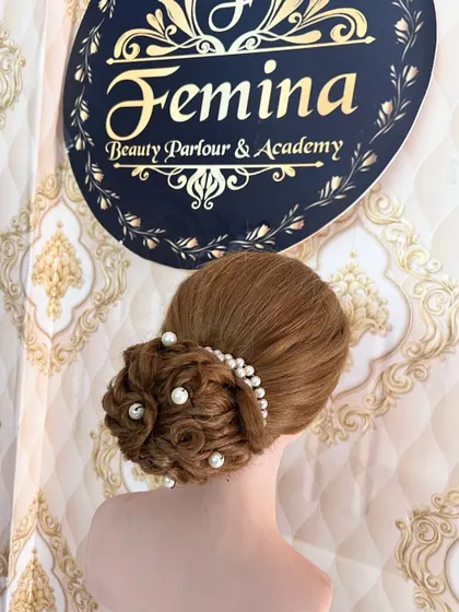 A side view of the woven pearl bun, highlighting the texture and placement of the pearls.