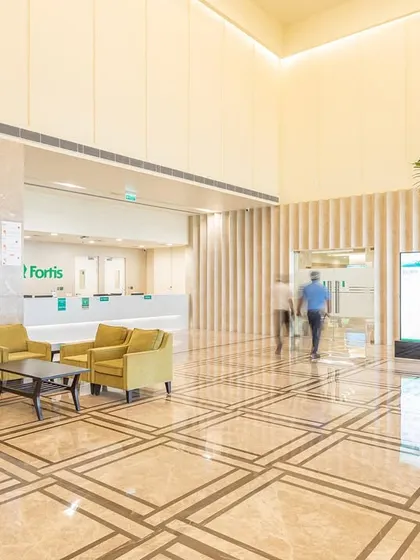The Fortis Hospital in Greater Noida showcases a successful hotel-to-hospital conversion. The grand lobby, a remnant of its past, is reimagined as a welcoming, spacious reception area, demonstrating how hospitality-driven design can enhance the patient experience in a clinical setting.