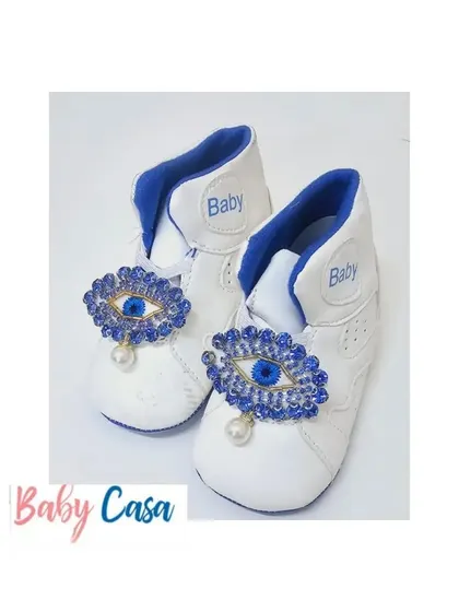 When a mom wants to protect her little dude from all evil eyes, she gets these custom shoes. These white baby booties feature a sparkling evil eye charm for style and protection.