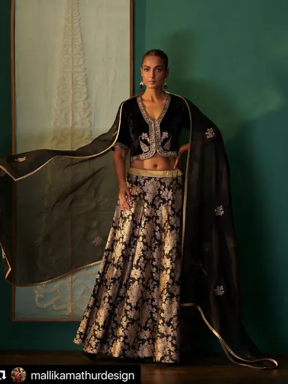 A classic black and gold combination. I paired a velvet hand-embroidered blouse with a silk brocade skirt for a rich, textural look that is perfect for a winter wedding reception.