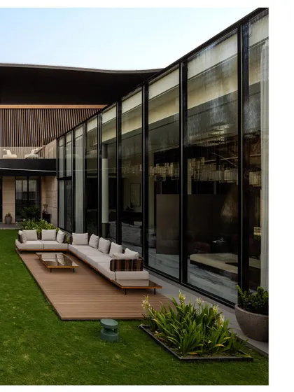 We design homes where life flows effortlessly between the indoors and the outdoors. This L-shaped layout for Residence Ondra was planned around a central lawn, with expansive glass walls that dissolve the barrier to nature. The result is a living space that feels open, airy, and constantly connected to the tranquility of the garden.