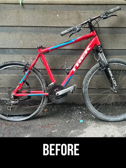 The 'before' state of the red Trek, with a flat tyre and a dirty frame. This is a typical starting point for our full restoration projects.
