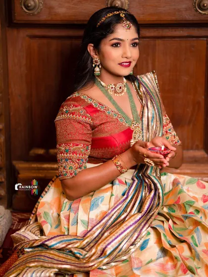 A festive shot of the model holding a diya, dressed in the beautiful leaf-printed Langa Voni.