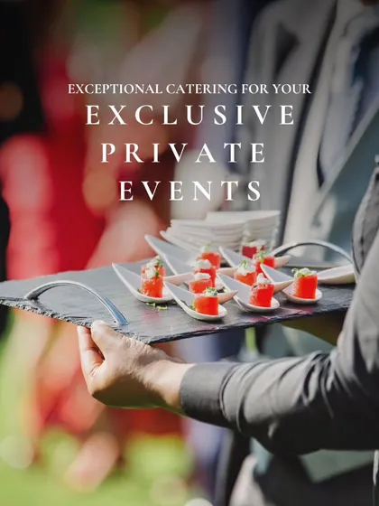 A server holding a tray of appetizers at an outdoor event. This image represents our promise of exceptional catering for exclusive private events.