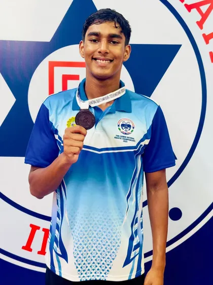 Dharshan S with his bronze medal in the 200m Butterfly.