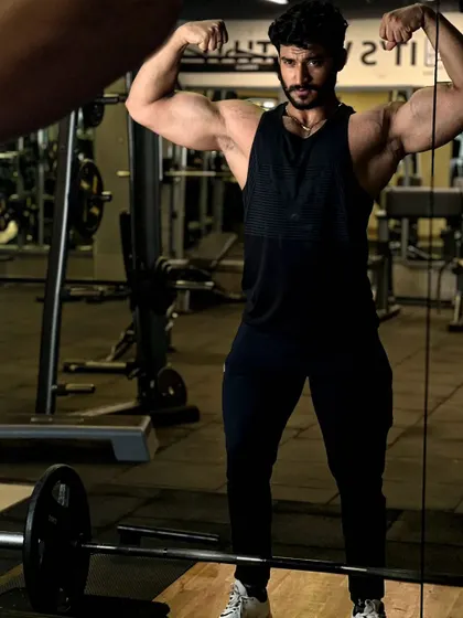 Life is a hurdle. A double biceps pose in the mirror.