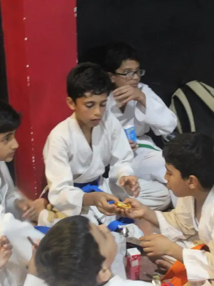 After the test, it's time to celebrate. Our young students enjoy some snacks together, building friendships and camaraderie after a challenging grading session.