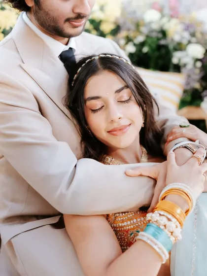 An intimate and romantic moment. The close-up shows the soft, shimmery eye makeup and the natural finish of the skin, perfect for these tender moments.