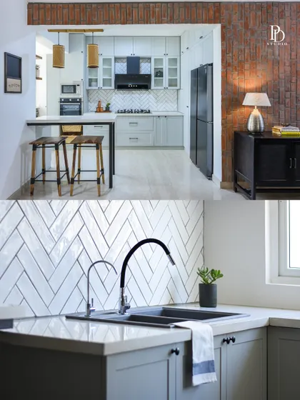 A look at the 'Earthy Urban' kitchen, which opens up to the dining area. The design features a herringbone tile backsplash, an exposed brick accent, and a practical breakfast bar for casual meals.