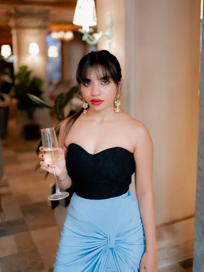 A duplicate of image 145, this chic portrait of a model holding a glass of champagne has a sophisticated and celebratory mood.