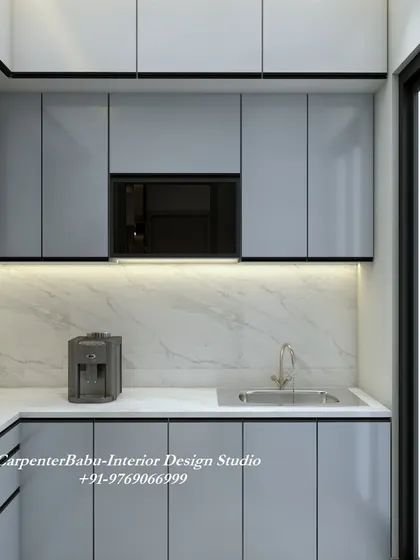 This kitchen uses a light grey laminate for the cabinets, creating a soft and contemporary feel. The open layout connects it to the rest of the living space.