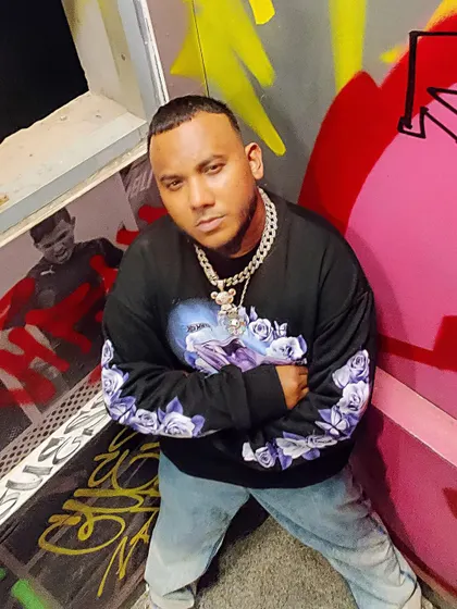 Posing against a graffiti wall. Street art is a huge part of the culture, and I incorporate these elements into my event branding and personal style.