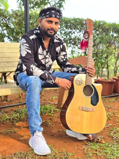 Posing with my trusted acoustic guitar. This instrument has been with me through countless performances and is like an extension of me.