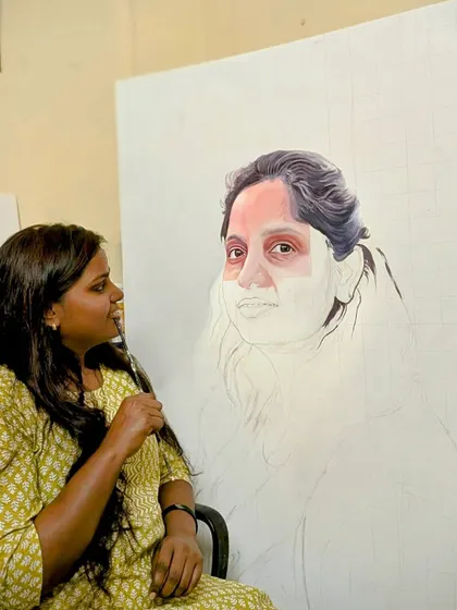 Here I am, deep in concentration, working on a large acrylic portrait. This shows my connection with the canvas as I bring the subject's likeness to life.