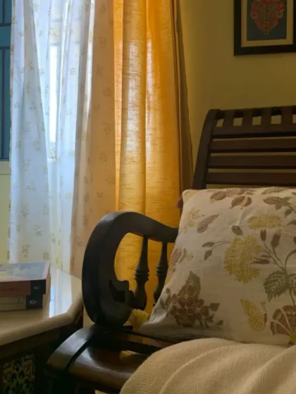 Sunlight streaming through our floral Posy and Dusky Yellow curtains creates pure poetry. This beautiful combination, styled in a client's home, adds a touch of magic and warmth to this cozy reading corner.