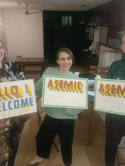 Happy clients holding their custom-painted signs. I enjoy creating personalized pieces that bring joy to people from all over the world.