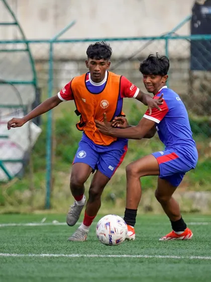 Two players challenge for the ball in a physical but fair duel. We teach our players to be strong and competitive while respecting the rules of the game.
