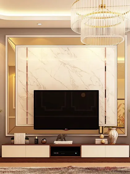 A symmetrical and elegant TV wall design. The central marble panel is flanked by mirrored borders and modern wall sconces, creating a balanced and luxurious focal point for the living room.