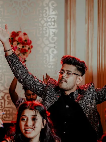 The groom leading the party on the dance floor. We capture the energy and excitement of the groom and his friends during the Sangeet.