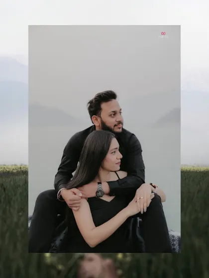 A romantic pre-wedding portrait of the couple by the water, framed by the vastness of the landscape, creating a feeling of serene togetherness.