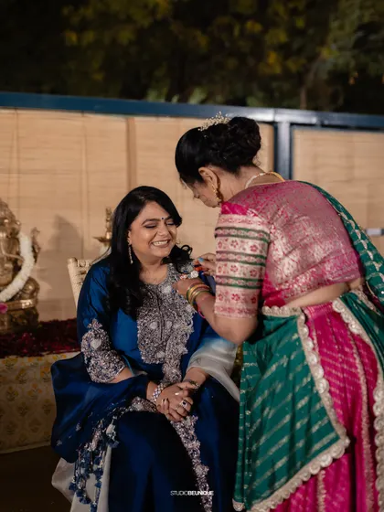 A behind-the-scenes moment of the bride getting her bindi placed, a small but significant detail that completes the look.