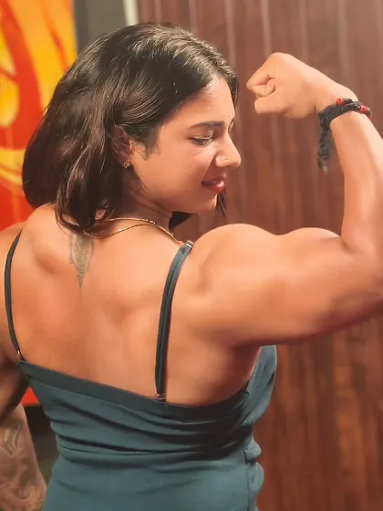 A powerful back and bicep pose, capturing the definition and size that comes from dedicated training.
