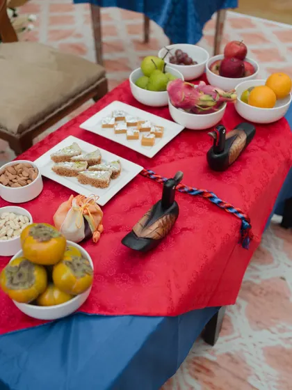 A close-up of the Paebaek ceremony table, showing the symbolic items including dates, chestnuts, and wooden mandarin ducks, which represent lifelong fidelity.