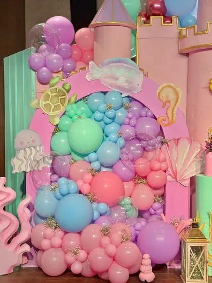 From a pastel soft play area and a cotton candy cart to a buffet with an LED screen backdrop showing aquatic life, every element was designed to immerse guests in Miraya's mermaid world.