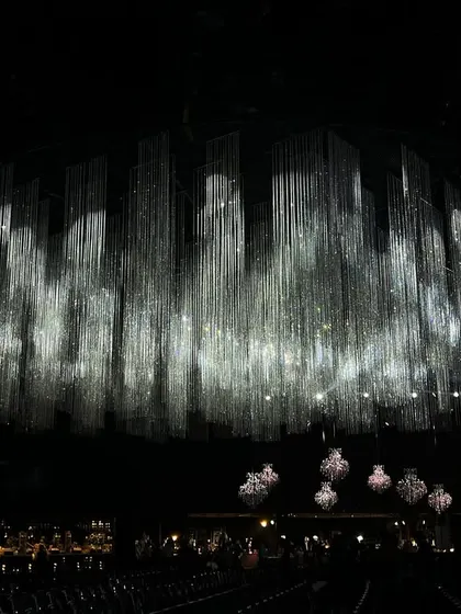 For a grand sangeet night, we created a breathtaking canopy of shimmering crystal tassels. This design shows how we use light and technology to craft an atmosphere of pure, understated elegance.