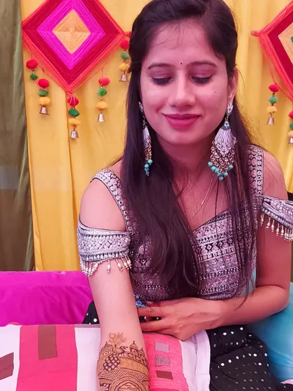 A lovely candid shot of a bride during her mehndi ceremony.