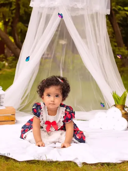 Another angle of our lovely outdoor canopy setup, capturing a curious toddler exploring the scene.