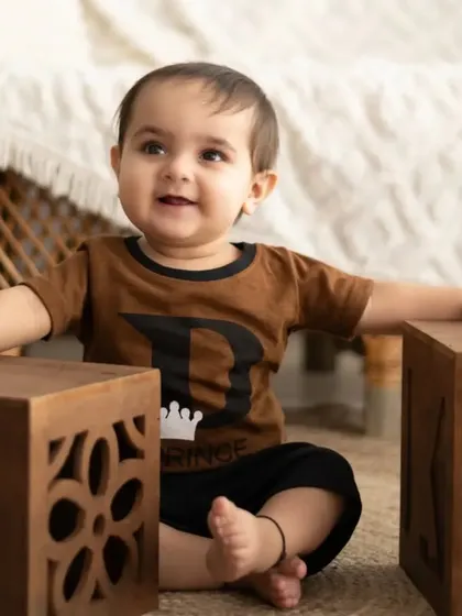 This little prince is taking his first steps with help from mom and dad. We love capturing these important milestones.