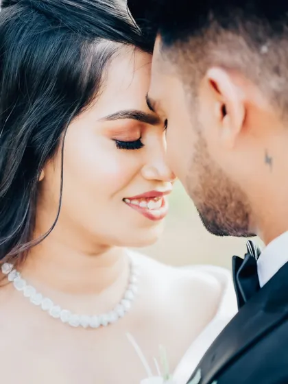 An intimate close-up. This shot captures the love and connection between the couple, as well as the bride's stunning, detailed makeup.