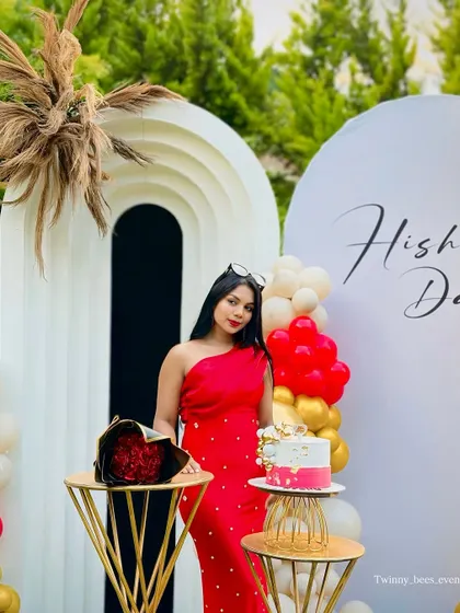 A closer look at the birthday girl, Hishu, and her stunning outdoor setup. The modern arches and bold red dress create a striking and fashionable birthday portrait.