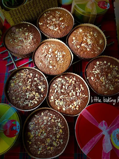 A fresh batch of non-alcoholic whole wheat plum cakes, just out of the oven and cooling on the rack. The aroma is absolutely divine.