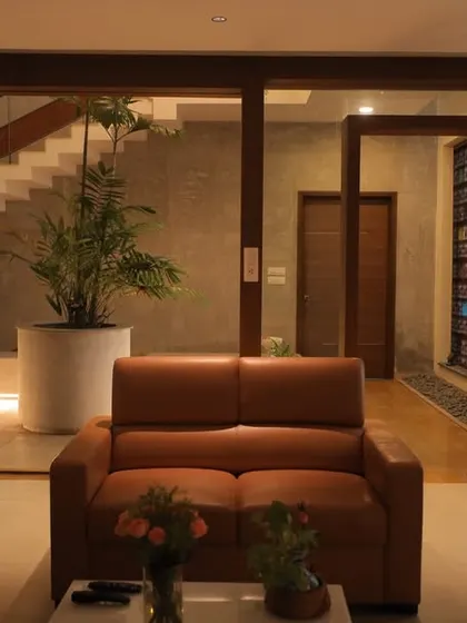 From the living room, the view opens up to the courtyard and staircase, showcasing the home's interconnectedness. The design ensures that nature and light penetrate deep into the living spaces.