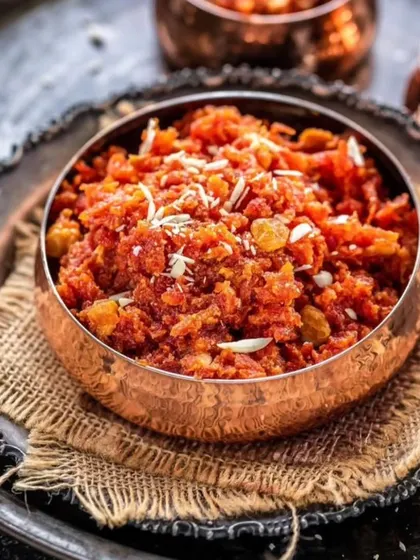 The ultimate winter comfort dessert, Gajar ka Halwa. We slow-cook grated carrots in milk and ghee, finishing it with nuts and raisins for that classic, heartwarming taste.