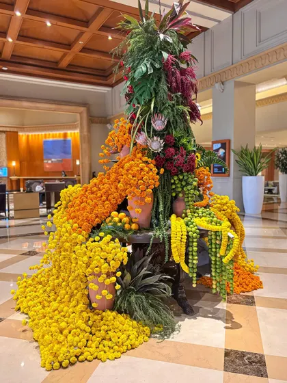 The sheer volume of flowers used in this piece creates a powerful and joyful statement.