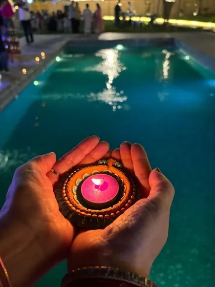 A serene moment during our Navratri celebration, with a guest floating a diya in the pool.