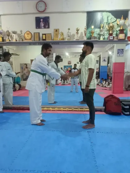 A student receives his green belt.