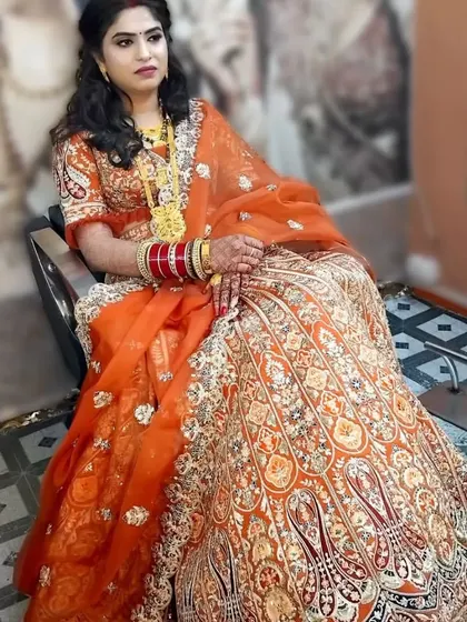 This is the same beautiful bride in her orange lehenga, showcasing her complete reception look. The makeup was designed to be comfortable and radiant for the entire event.