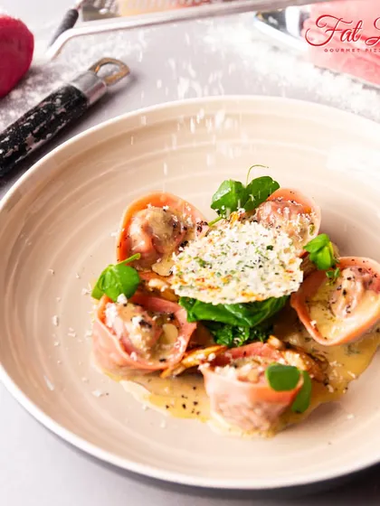 The final product from one of our classes. This dish features beautiful pink beetroot ravioli, delicately plated with sauce and a parmesan crisp.