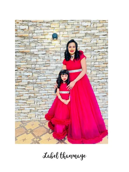 I designed these vibrant red gowns for a mother and daughter. The daughter's dress has a fun ruffled hem, perfect for twirling.