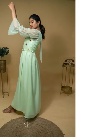 This teal green net georgette dress is the picture of effortless grace. The floor-length silhouette is light and flowing, perfect for dancing the night away.