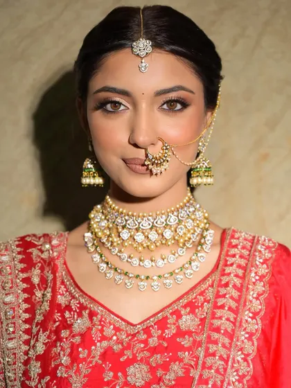 A beautiful portrait showcasing the flawless base and defined eyes. The makeup is designed to enhance her features while staying true to her skin tone.