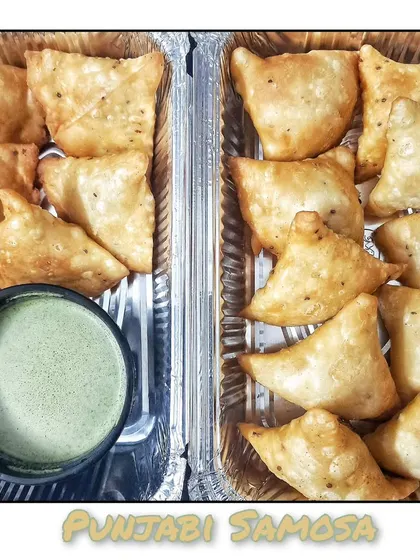 Classic Punjabi Samosas, perfectly spiced and fried until golden brown, served with my homemade green chutney.
