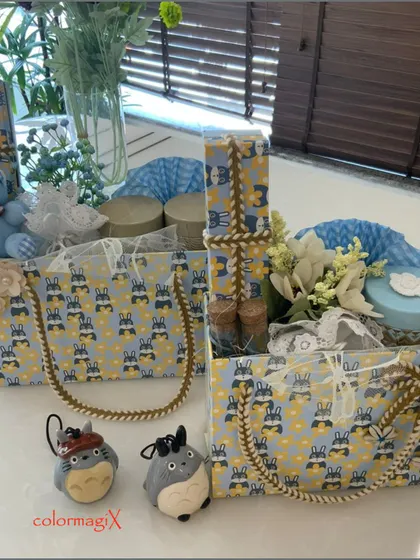 Another view of our blue-themed baby boy hampers. The image highlights the patterned gift totes with sturdy rope handles, filled with a mix of essentials and decorative items.