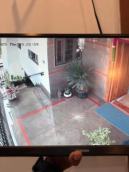 This camera is positioned to monitor the main entrance and porch of a house. The wide angle lens covers the entire entryway.
