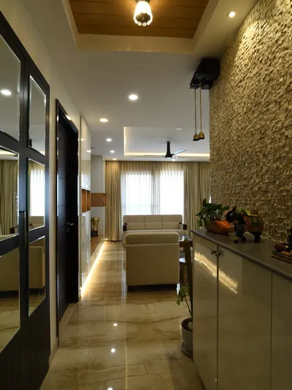 Looking down the hallway from the foyer, this view shows how the textured wall and lighting guide you into the main living area.