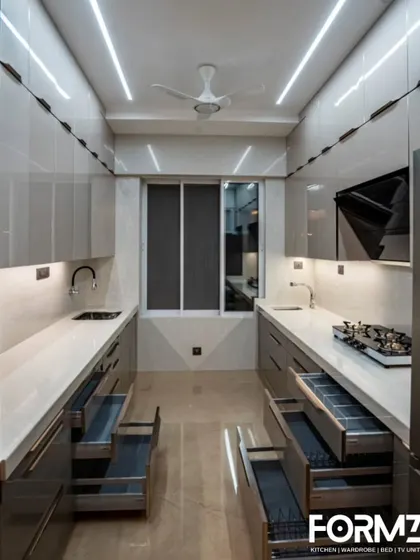A full view of a parallel kitchen with high-gloss lacquered glass cabinets. This design maximizes vertical storage and uses reflective surfaces and linear lighting to create a spacious and ultra-modern feel.